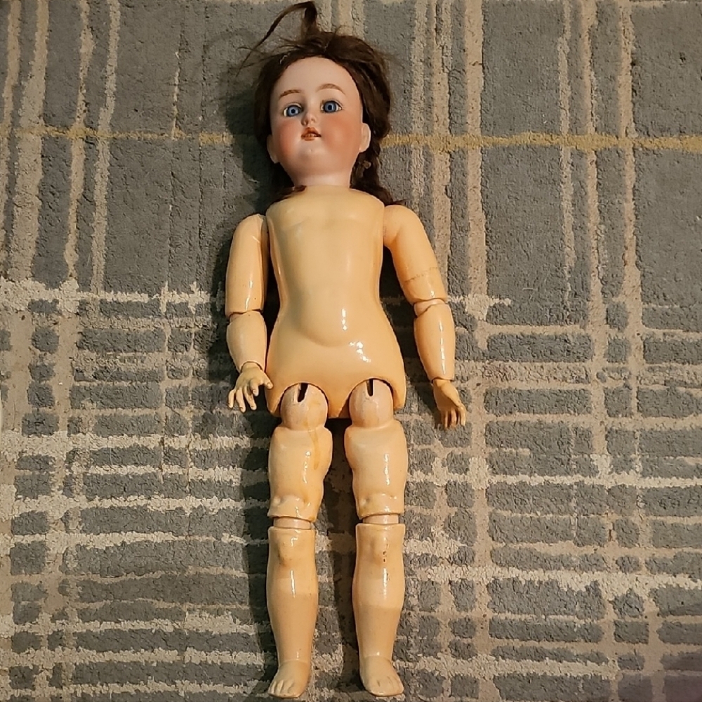 Antique Porcelain Doll with Blue Eyes and Brown Hair